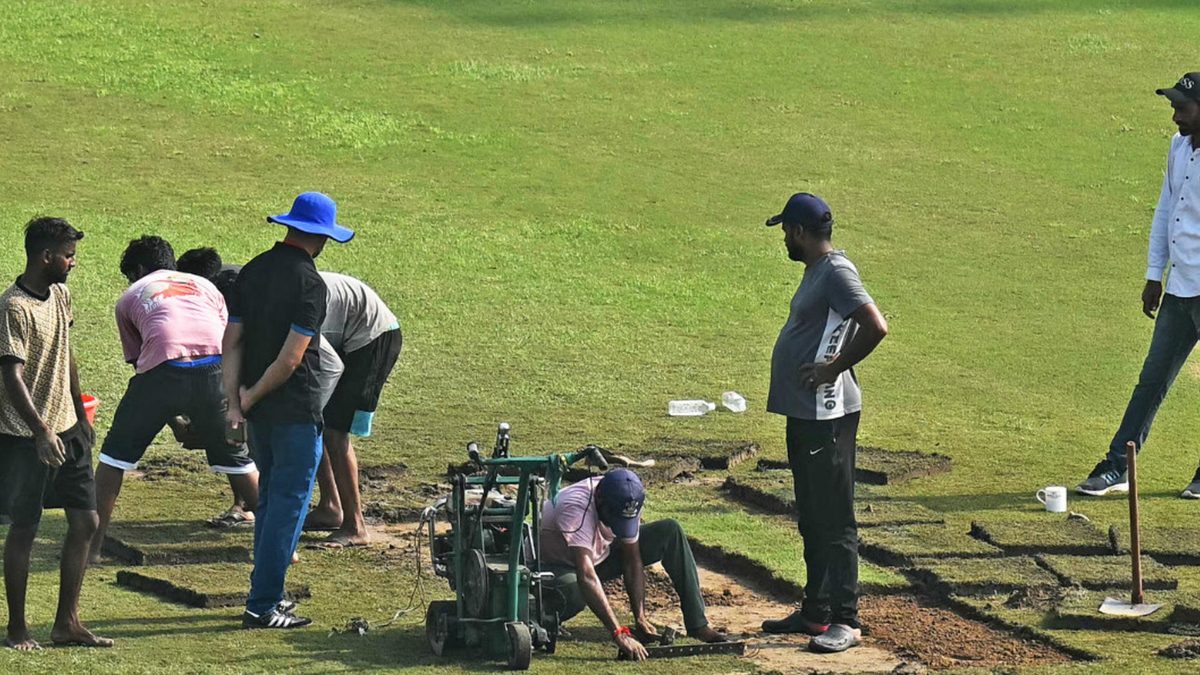 Groundsmen prepare the field with artificial grass before the start of the one-off Test cricket match between Afghanistan and New Zealand at the Shaheed Vijay Singh Pathik Sports Complex in Greater Noida on September 10, 2024