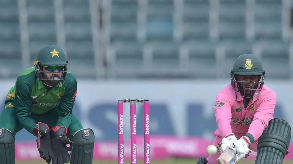 South Africa's captain Temba Bavuma (R) plays a shot as Pakistan's wicketkeeper Mohammad Rizwan (L) looks on during the second one-day international (ODI) cricket match between South Africa and Pakistan at Wanderers Stadium in Johannesburg on April 4, 2021. - The South African team's kit and the wickets are pink to raise awareness for breast cancer